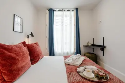 a bedroom with a bed with a plate of food on it at Bright & Characterful Home by HostWise in Porto