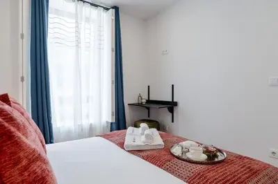 a hotel room with a bed with a tray of towels at Bright & Characterful Home by HostWise in Porto