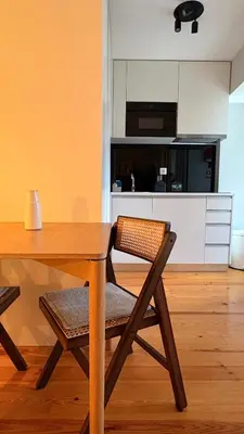 a desk with a lamp and a chair in a room at Porto Central Apartment in Porto