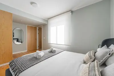 a bedroom with a large bed with towels on it at GuestReady - Top floor lodge with a stunning view in Porto