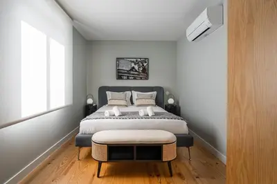 a bedroom with a large bed and a window at GuestReady - Top floor lodge with a stunning view in Porto