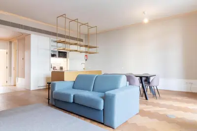 a white bedroom with a bed and a large window at Entreparedes House in Porto
