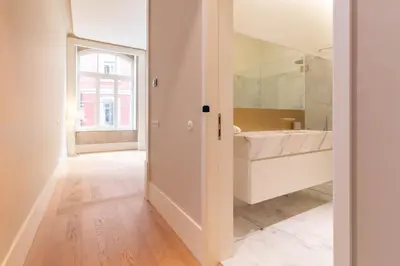 a bathroom with a tub and a sink and a mirror at Entreparedes House in Porto