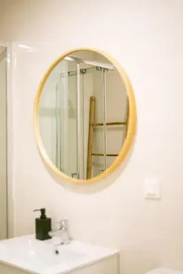 a bathroom with a sink and a mirror on the wall at Magnificent Cais de Gaia Duplex in Vila Nova de Gaia