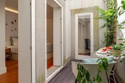 a room with a bath tub and a bedroom at City Center Lello and Clerigos 5min Walk with Free Parking in Porto