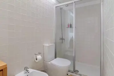 a bathroom with a shower and a toilet and a sink at City Center Lello and Clerigos 5min Walk with Free Parking in Porto