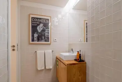a bathroom with a sink and a mirror at City Center Lello and Clerigos 5min Walk with Free Parking in Porto