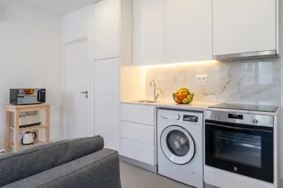 a kitchen with a washing machine and a sink at Bonfim Charming Flats by HostWise in Porto