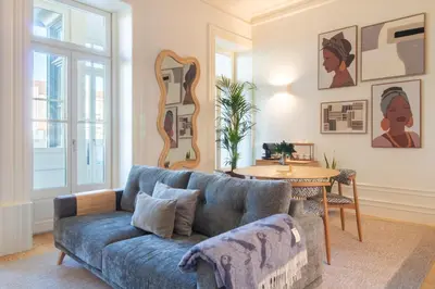 a living room with a blue couch and a table at Deluxe Design 1BR w Terrace by LovelyStay in Porto