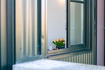 a window with a vase of flowers on a window sill at Deluxe Design 1BR w Terrace by LovelyStay in Porto