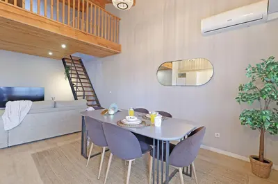 a dining room table and chairs in a living room at ON Apartments - Family - Free Parking & Pet Friendly in Porto