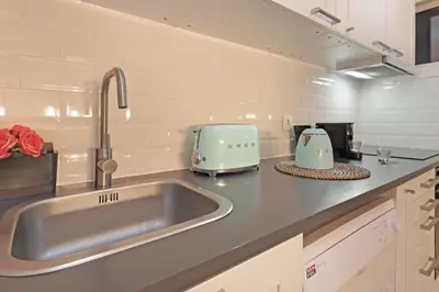 a kitchen with a sink and a toaster on a counter at ON Apartments - Family - Free Parking & Pet Friendly in Porto