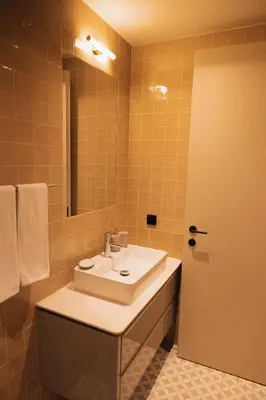 a bathroom with a sink and a mirror at Casa de Santa Catarina by OportoSoul in Porto