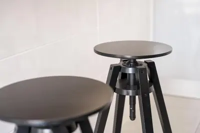 a black stool next to a table and a stool at GuestReady- Charming Porto Retreat with Terrace in Porto