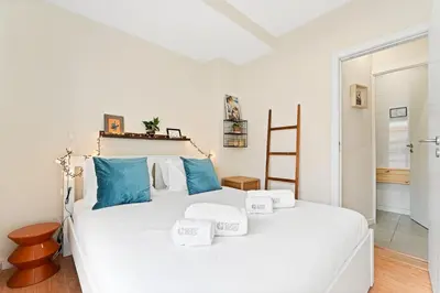 a bedroom with a large white bed with blue pillows at GuestReady- Charming Porto Retreat with Terrace in Porto
