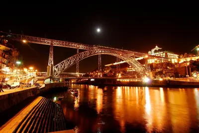 a large bridge over a river at night at Welcome to my city 2 in Porto