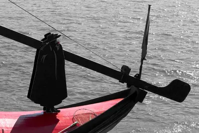 a person in a robe is standing on a boat at Welcome to my city 2 in Porto