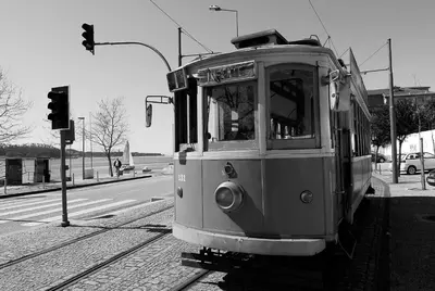 a trolley car on a street with a traffic light at Welcome to my city 2 in Porto