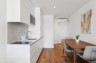 a kitchen and dining room with a wooden table at GuestReady - Elegant stay in Central Porto in Porto