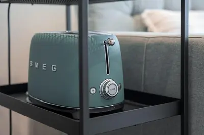 a toaster sitting on a black table next to a couch at GuestReady - Elegant stay in Central Porto in Porto