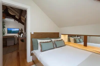 a bedroom with a large white bed with blue pillows at The Terraced Loft - Boho Elegance in Porto in Porto