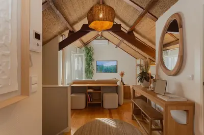 a room with a desk and a table in a room at The Terraced Loft - Boho Elegance in Porto in Porto