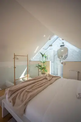 a white bed with a blanket on top of it at The Dome in Porto