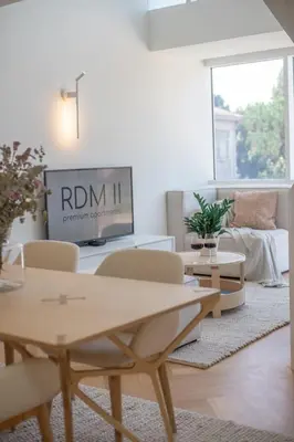 a living room with a table and chairs and a tv at The Dome in Porto