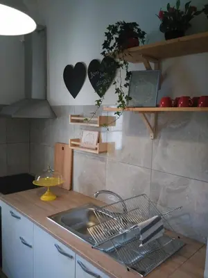 a kitchen with a sink and a counter with hearts on the wall at Lulapartment II in Porto