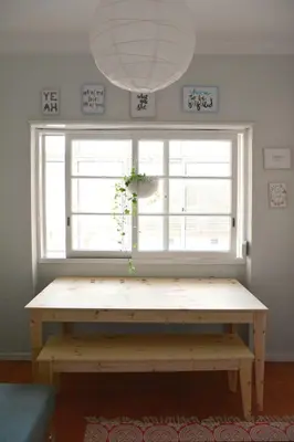 a wooden bench in front of a window at Lulapartment II in Porto