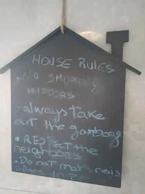 a sign hanging on a wall with a cross on it at Lulapartment II in Porto
