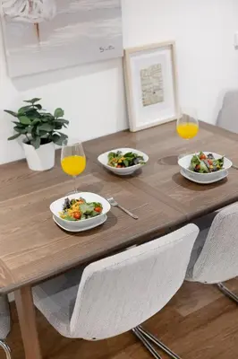 a wooden table with plates of food and glasses of orange juice at Timeless Porto Studio @ Marquesa Palace in Porto