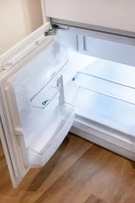 an empty refrigerator with its door open at Serene Porto Studio @ Marquesa Palace in Porto