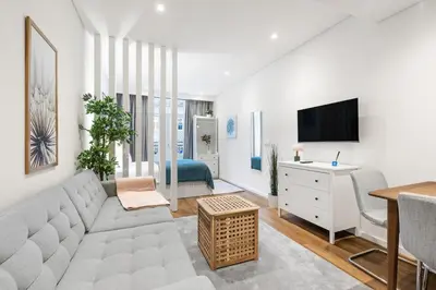 a living room with a couch and a tv at Serene Porto Studio @ Marquesa Palace in Porto