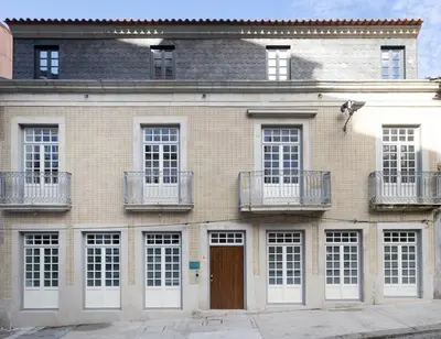 a brick building with white windows and a brown door at Serene Porto Studio @ Marquesa Palace in Porto