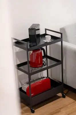 a black cart with a coffee maker and a microwave at Serene Porto Studio @ Marquesa Palace in Porto