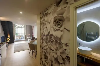a bathroom with a sink and a shower and a mirror at Ribeira Apartments São João in Porto