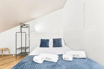 a white bedroom with a bed with towels on it at GuestReady - Charming Porto retreat in Porto