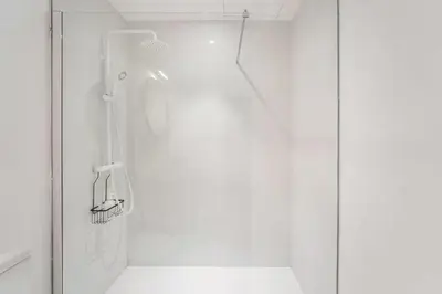 a shower with a glass door in a bathroom at Vila Rio Guest House in Vila Nova de Gaia