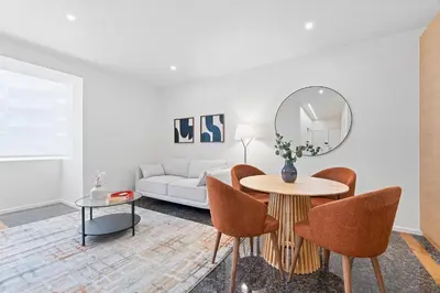 a living room with a white couch and a table at GuestReady - Marble Branch in Porto