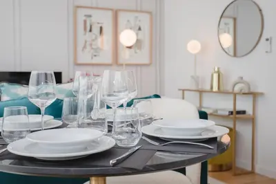 a table with plates and wine glasses on it at GuestReady - Soho urban retreat in Porto