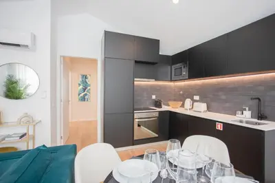 a kitchen with a table with wine glasses on it at GuestReady - Soho urban retreat in Porto
