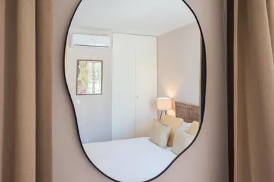 a mirror hanging on a wall with a small room at Uma Poveiros in Porto
