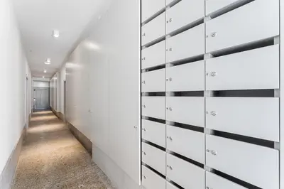 a hallway with white walls and black and white closets at Modern 1BR Apartment - Brand New Bonjardim I in Porto