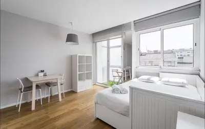 a bedroom with a bed with yellow and white pillows at Bolhão Luxe Retreat 2 in Porto