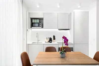 a dining room with a wooden table and chairs at Stay Bonjardim - Modern Garden Duplex M in Porto