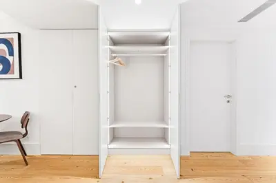 a white closet with white shelves in a room at Unique Luxury and Quiet in Porto Best Location in Porto