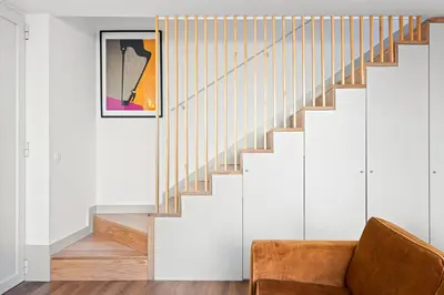 a living room with a staircase and a couch at Stay Bonjardim - Modern Garden Duplex N in Porto