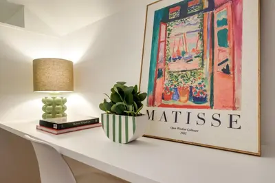 a white table with a picture and a lamp and a plant at Duque 3 Luxury Apartment Downtown Porto near Metro in Porto