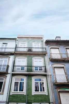 a tall building with balconies on the side of it at Alma D'oporto 556 – Elegant T1 in Porto